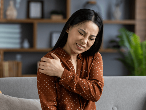 Woman holding shoulder